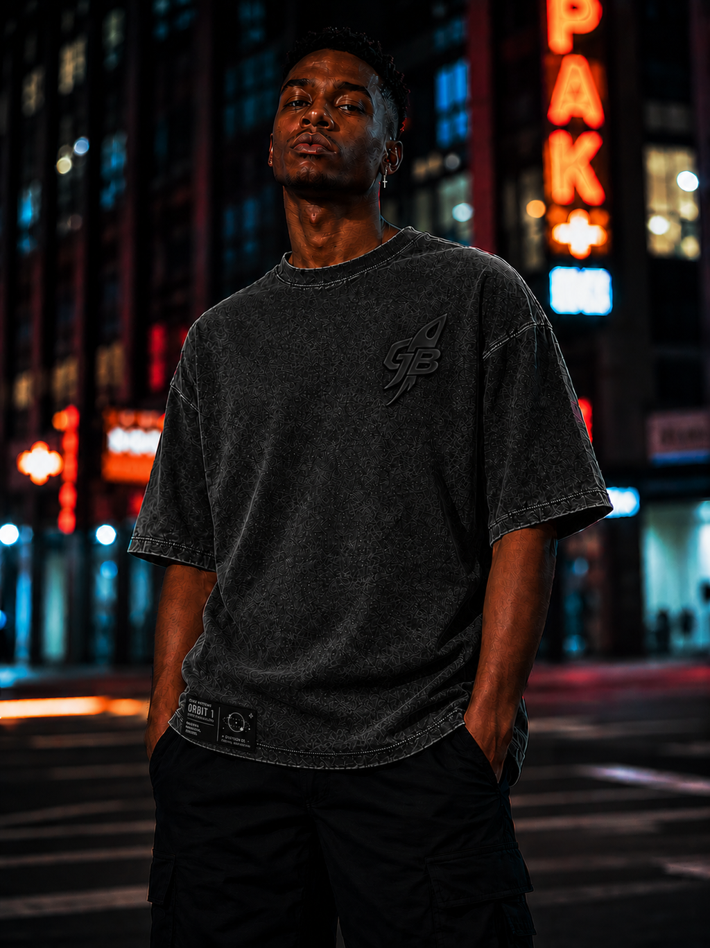 Model wearing the GLXY Orbit 001 Vintage Black t-shirt while walking through a city street