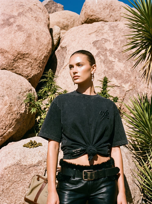 Close-up of female model wearing the GLXY Orbit 001 Vintage Black acid-wash t-shirt, front view